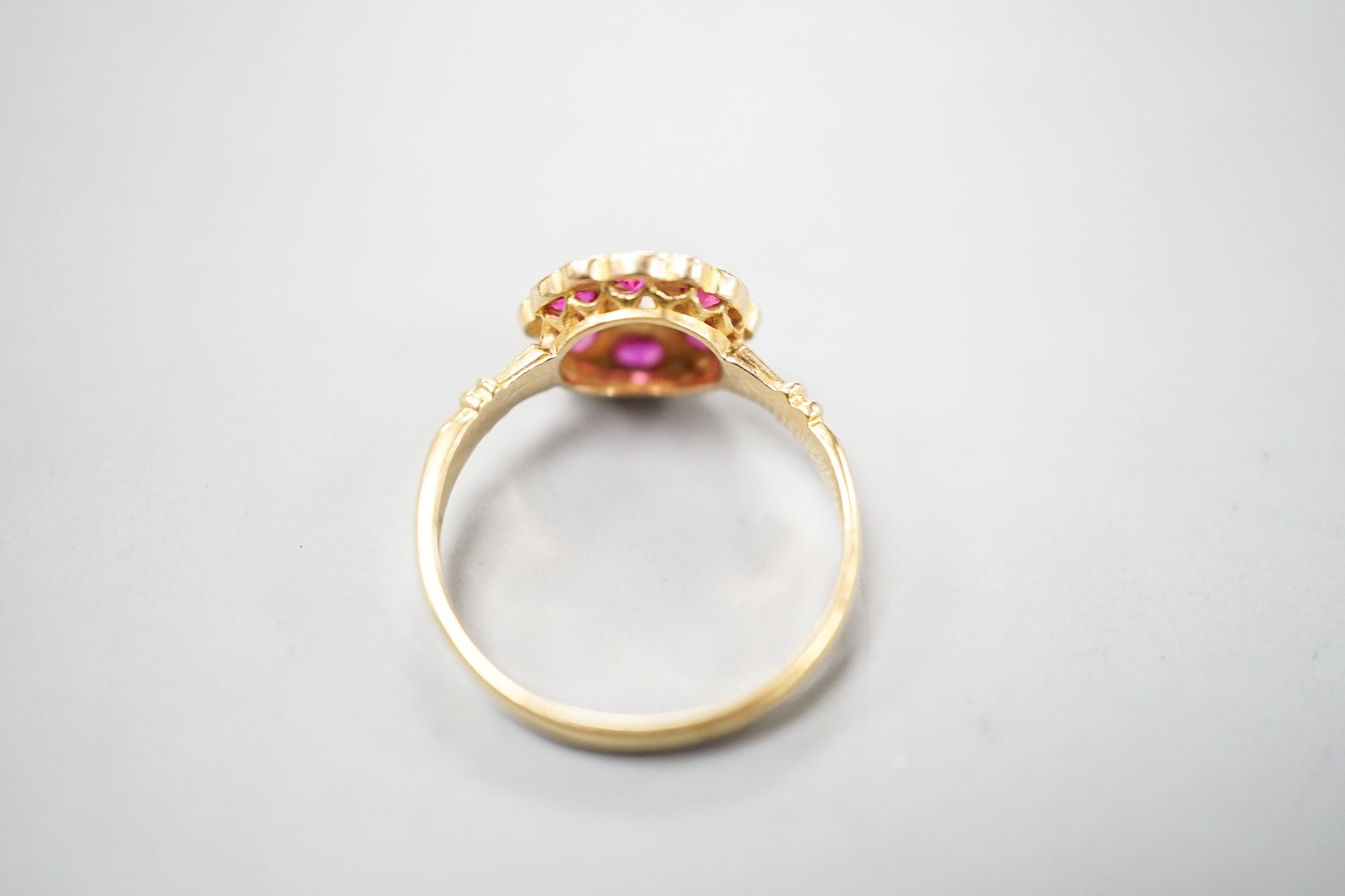 A George V 18ct gold, synthetic ruby, white sapphire? and diamond chip set cluster ring, size K, gross weight 2.4 grams.